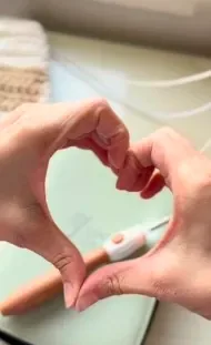 Hands making a heart shape around the counting hook